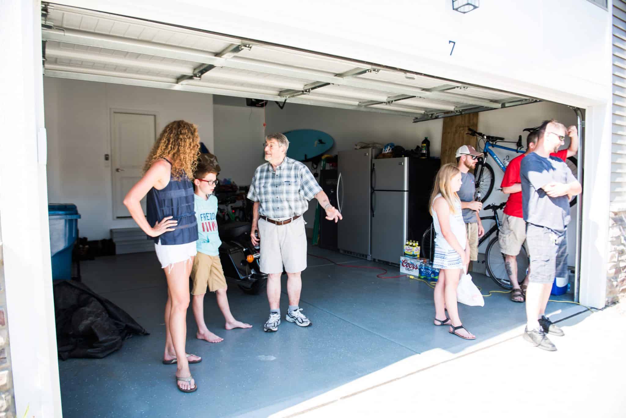 Apex employees and family members hanging out in a garage