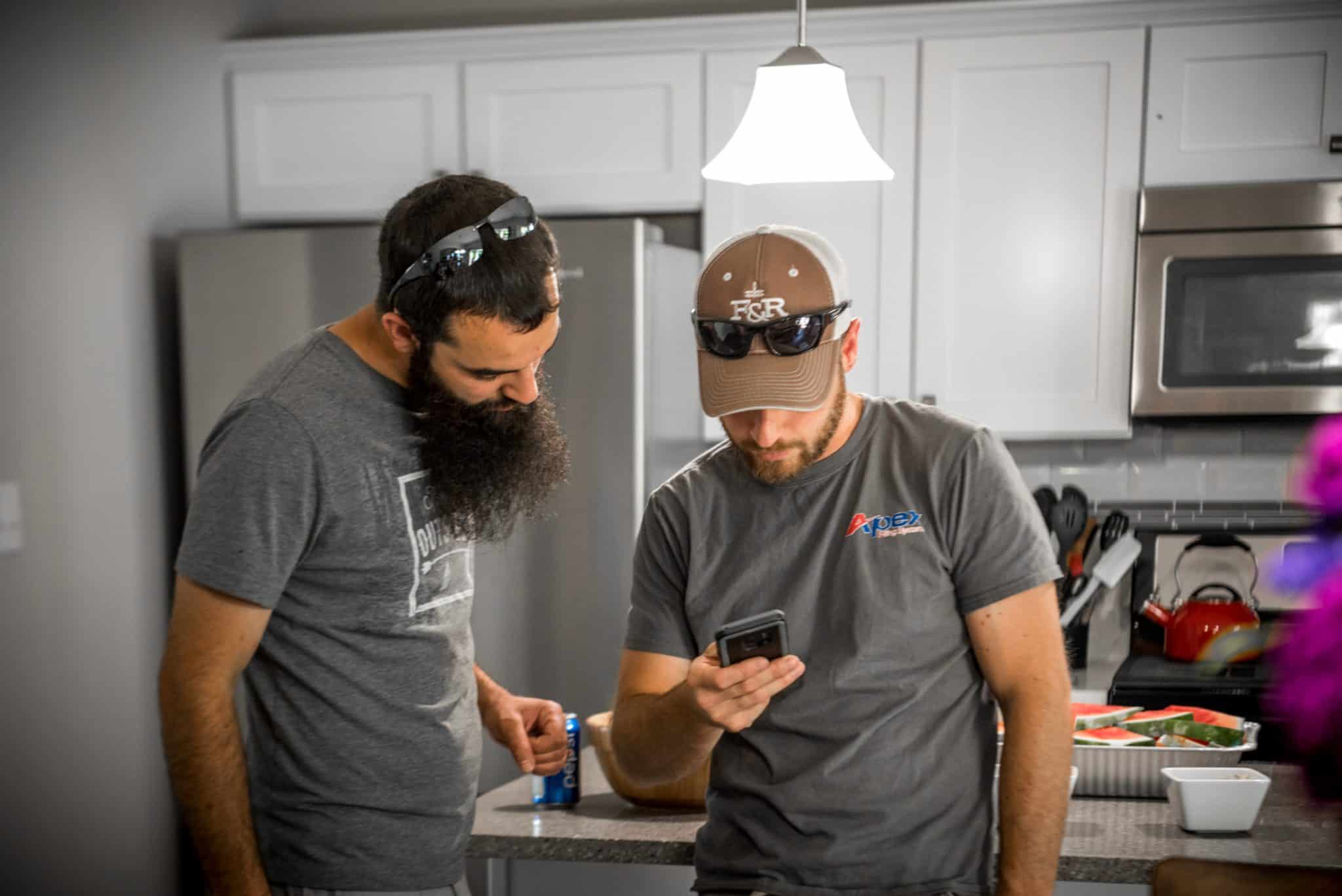 Apex employees looking at a cell phone