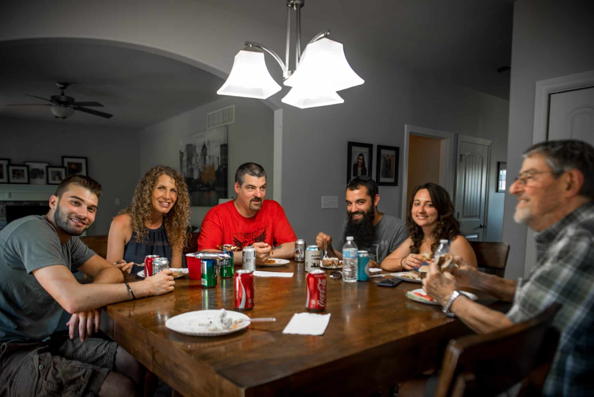 Apex employees and family members enjoying food and drinks at a table