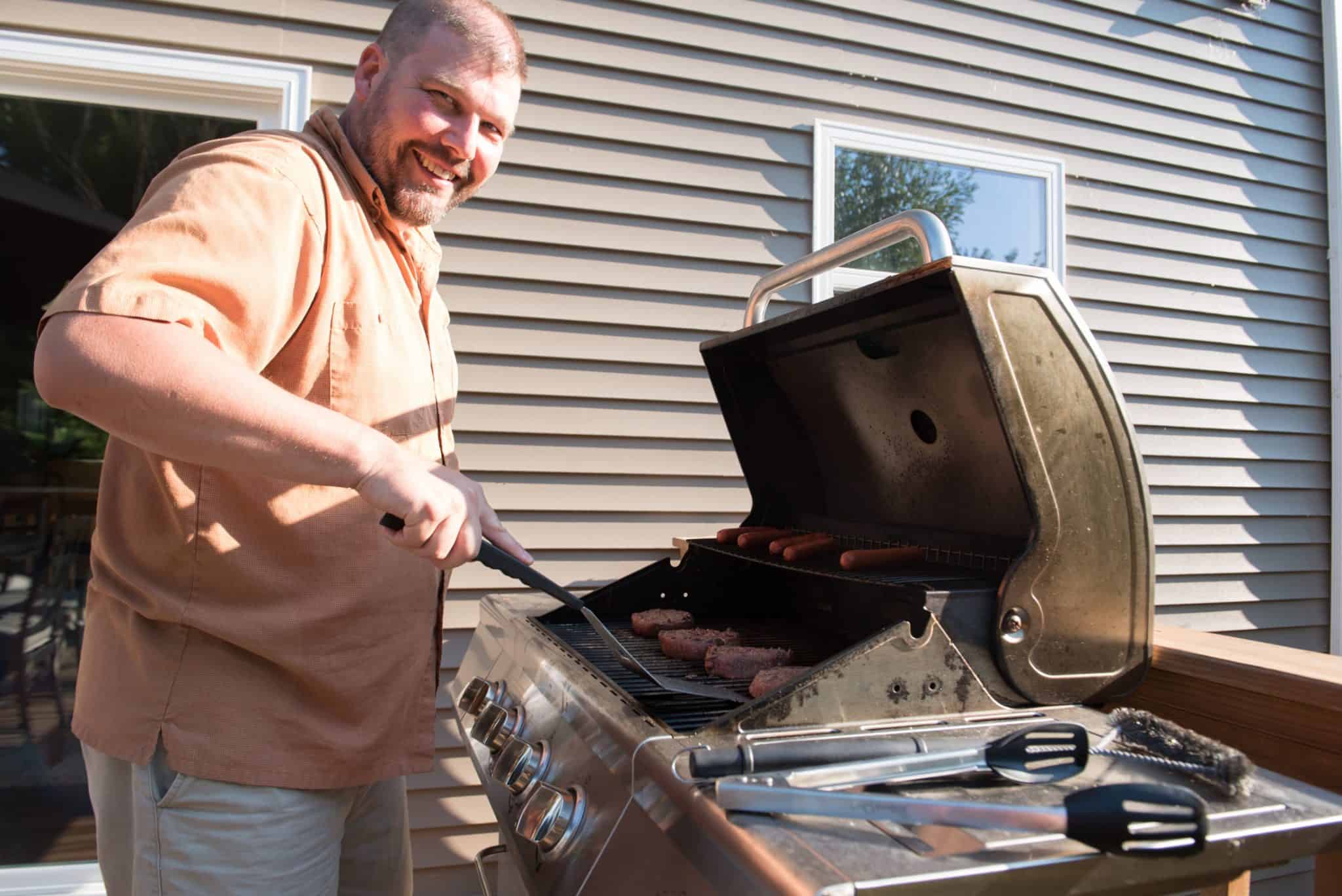 Grilling hamburgers for the Apex Filling Systems family cookout