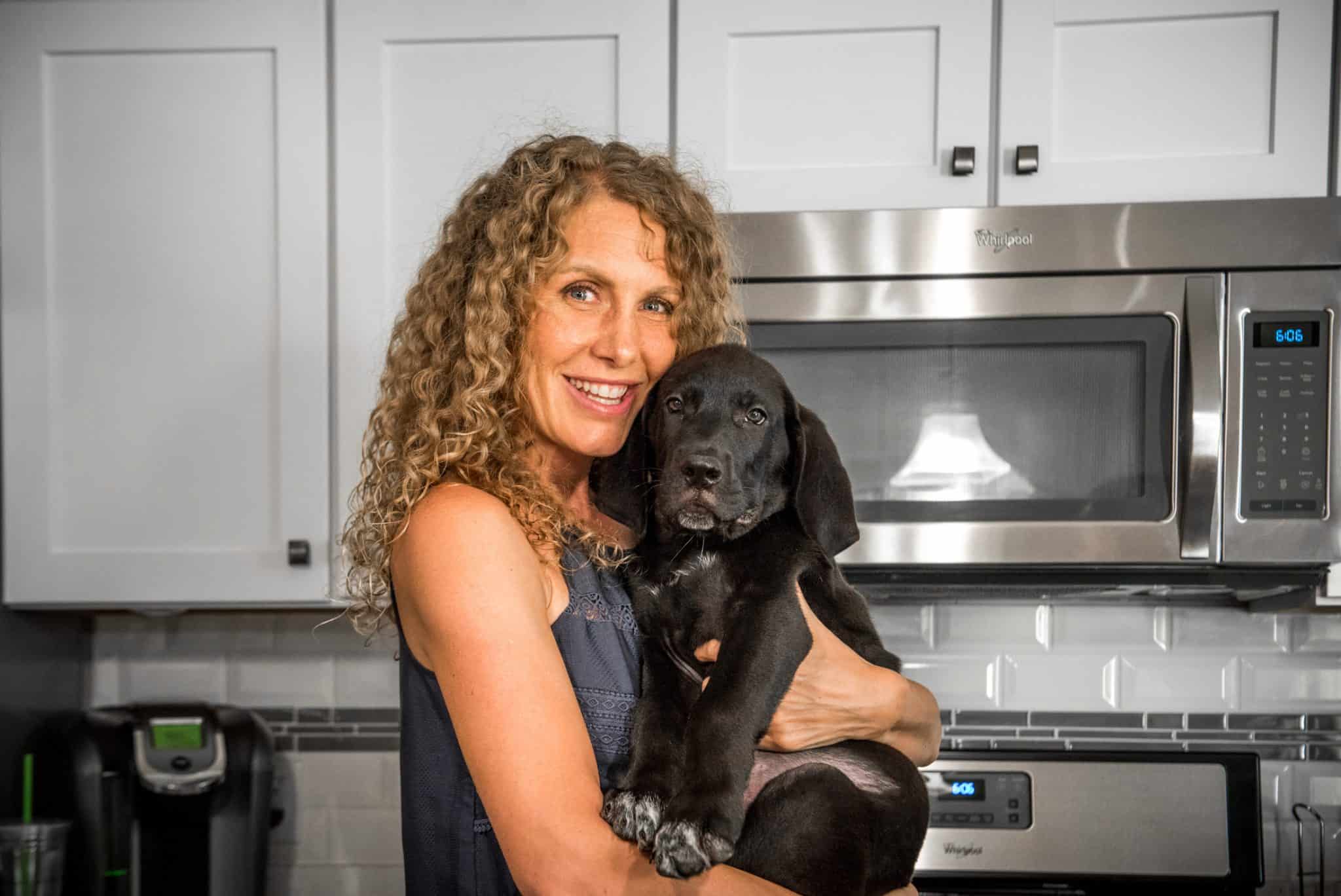 Holding Roman the black lab puppy 