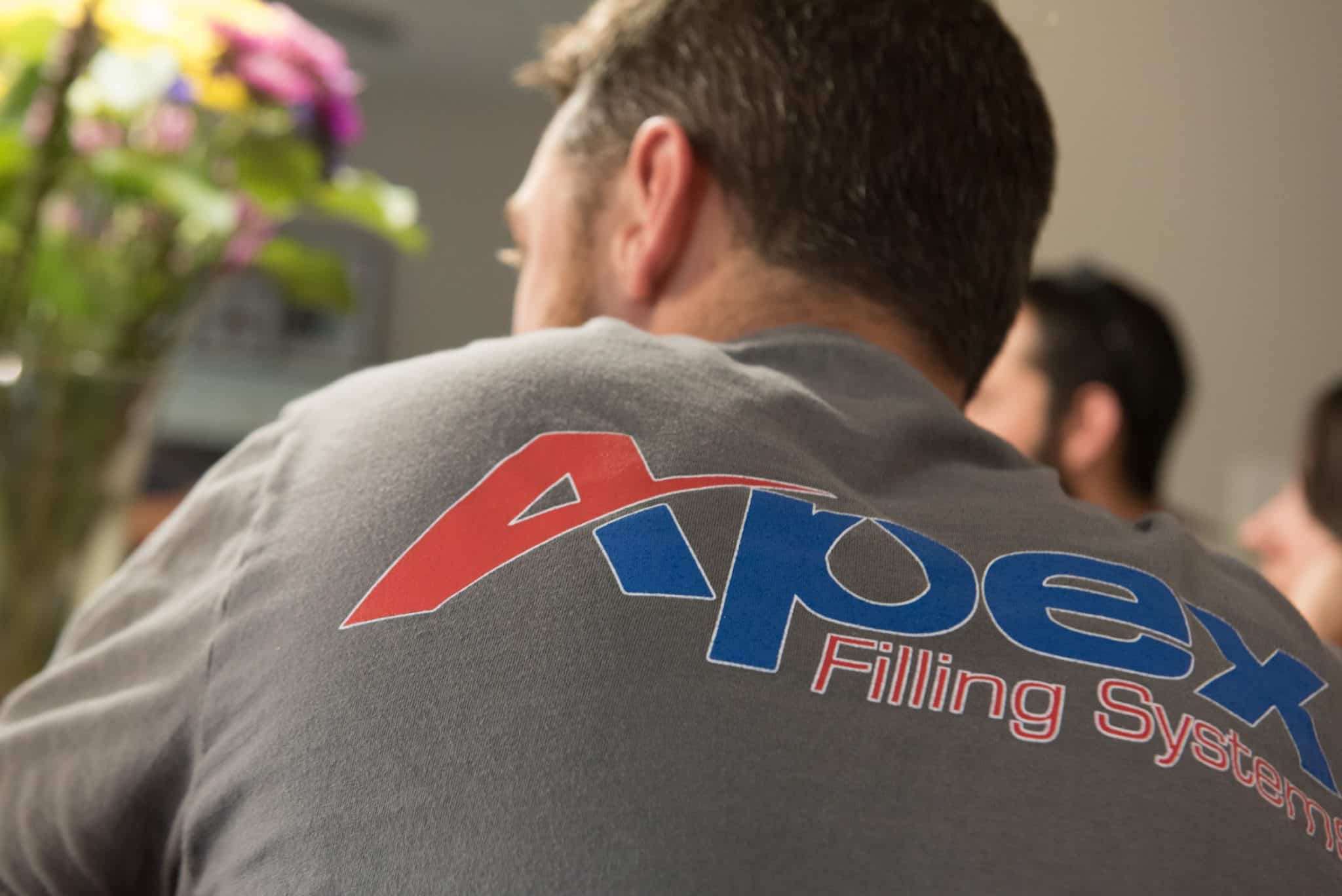 Closeup of an Apex Filling Systems t-shirt