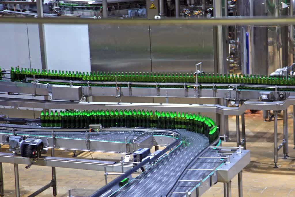 Bottles getting filled on conveyor belt