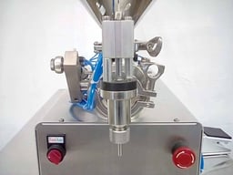 Close up of a semi-automatic tabletop piston filler