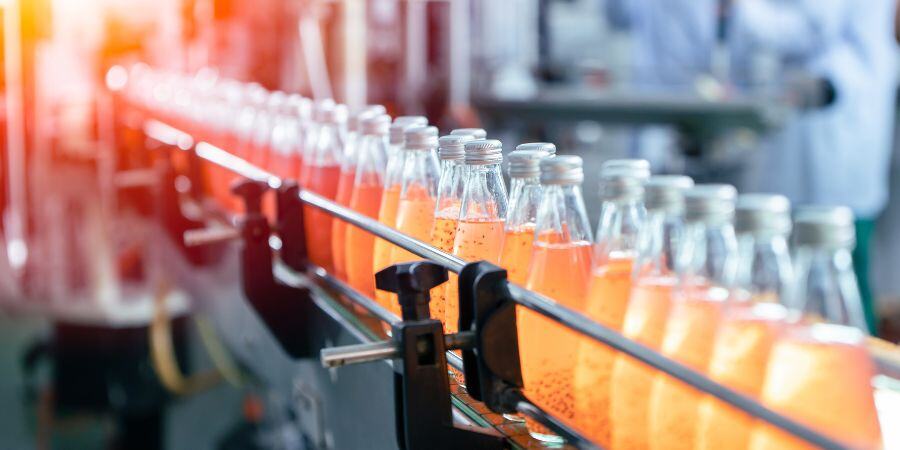 Bottles on an Apex Conveyor after being filled and capped 