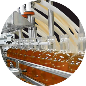 Close-up of an overflow filler in action, precisely filling bottles with alcoholic spirits, showcasing efficiency and consistency in liquid packaging.