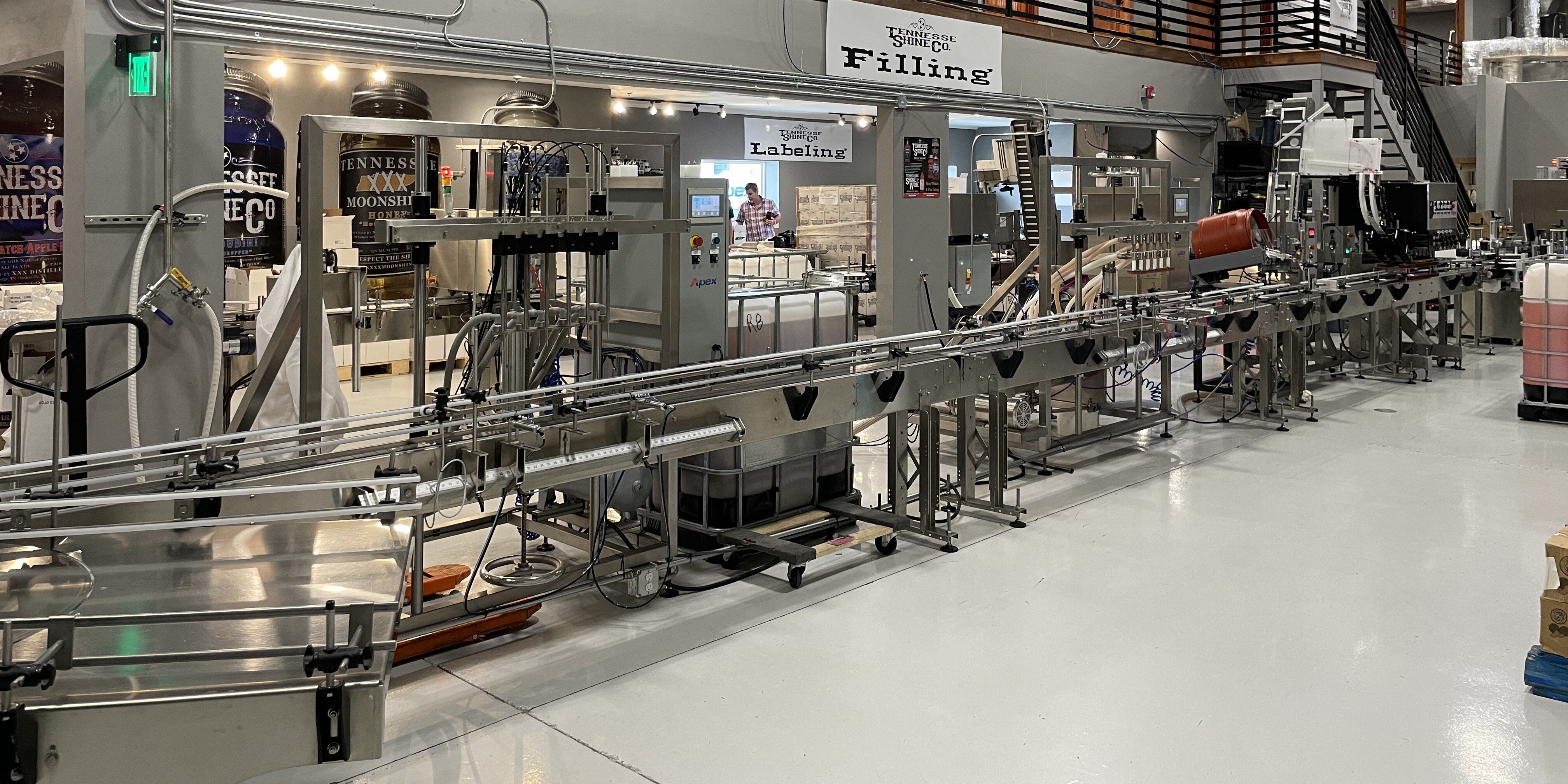 Tennessee Shine Filling Line: Pressure Overflow Filler, Bottle Rinser, Spindle Capper, Labeler